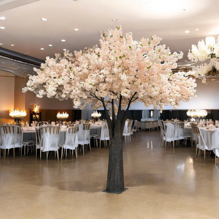Decorative 15 ft cherry blossom tree in a large indoor setting with tables and chairs.