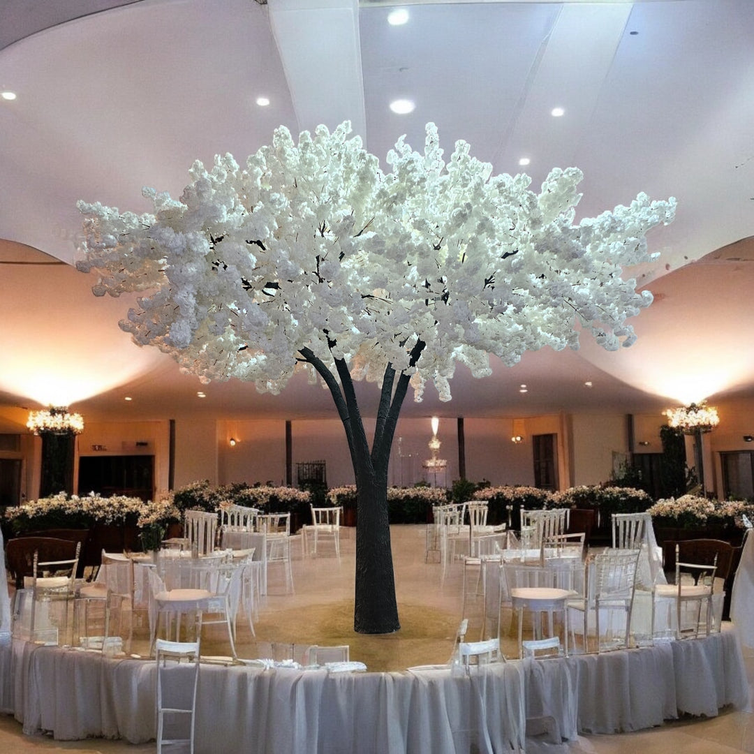 Magnificent artificial white cheery blossom tree with cascading white blossoms, set as a centerpiece in an elegantly decorated wedding venue in GTA.