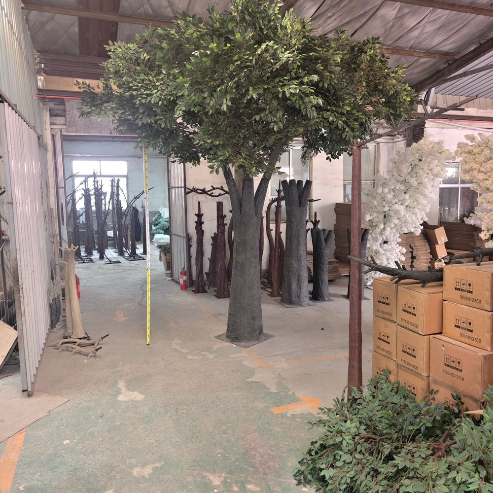 Tall artificial ficus tree with layered green leaves creating a realistic canopy for modern indoor décor.