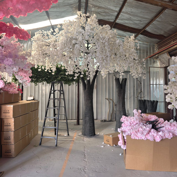 15ft Artificial cherry blossom trees and pink flowers in a warehouse setting with boxes.