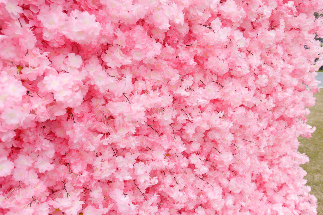 Close-up view of a pink artificial flower wall backdrop, popular for weddings, parties, and photoshoots. 
How durable is an artificial flower backdrop? Can it be used multiple times? How do I clean and store a flower wall backdrop? Does this backdrop require assembly?