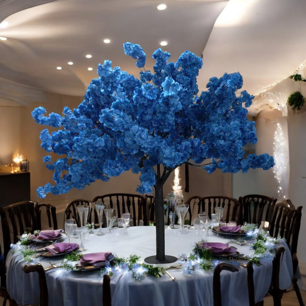 Decorative blue floral centerpiece on a table set for a formal event.