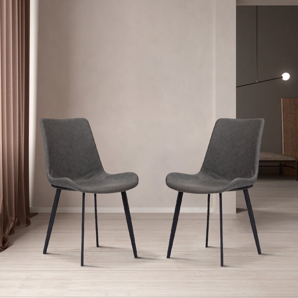 Pair of modern dark gray dining chairs with black metal legs in a minimalist interior. Frequently asked questions include 'What are the best dining chairs for small spaces?' and 'How do I choose a comfortable dining chair for long meals?