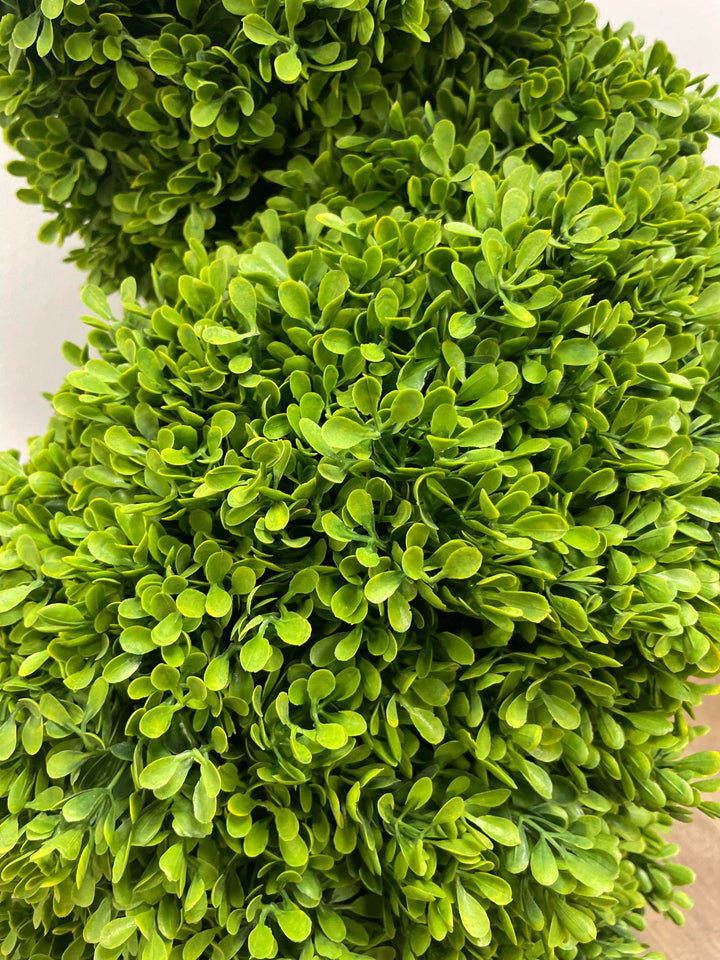Close-up of lush, vibrant green artificial boxwood foliage, perfect for indoor or outdoor decoration.