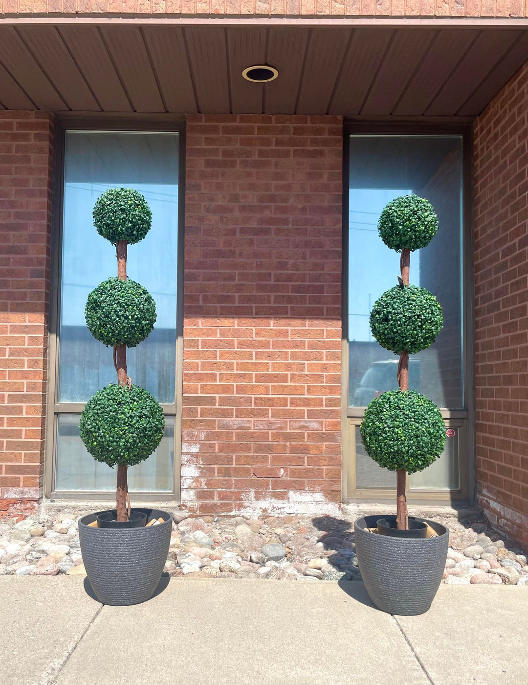Pair of outdoor artificial topiary trees featuring three ball-shaped tiers in stylish black planters, perfect for enhancing entryways, patios, or garden spaces with a touch of modern greenery