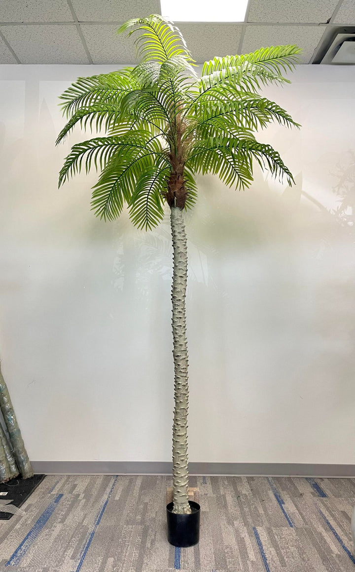 Artificial tall palm tree in a black planter, featuring a textured trunk and lush green fronds, perfect for adding a tropical touch to indoor spaces.