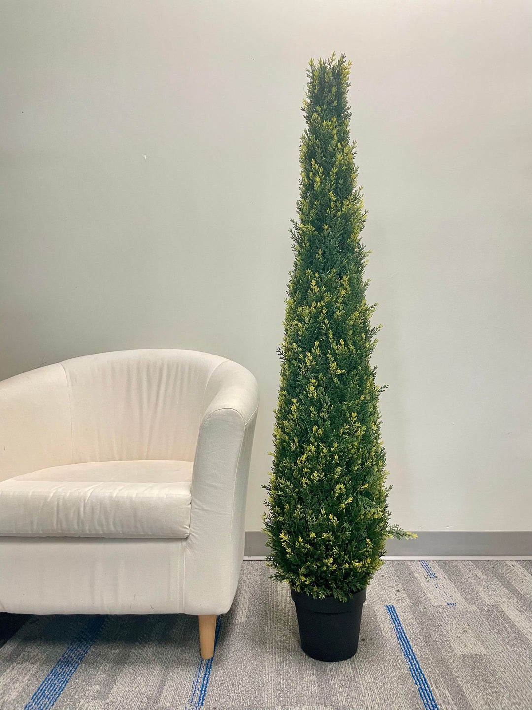 Artificial tall evergreen plant in a black pot, featuring lush green foliage with subtle yellow accents, perfect for outdoor or indoor decor