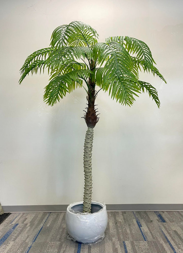  Artificial palm tree in a stylish office adding a natural touch to a professional setting.