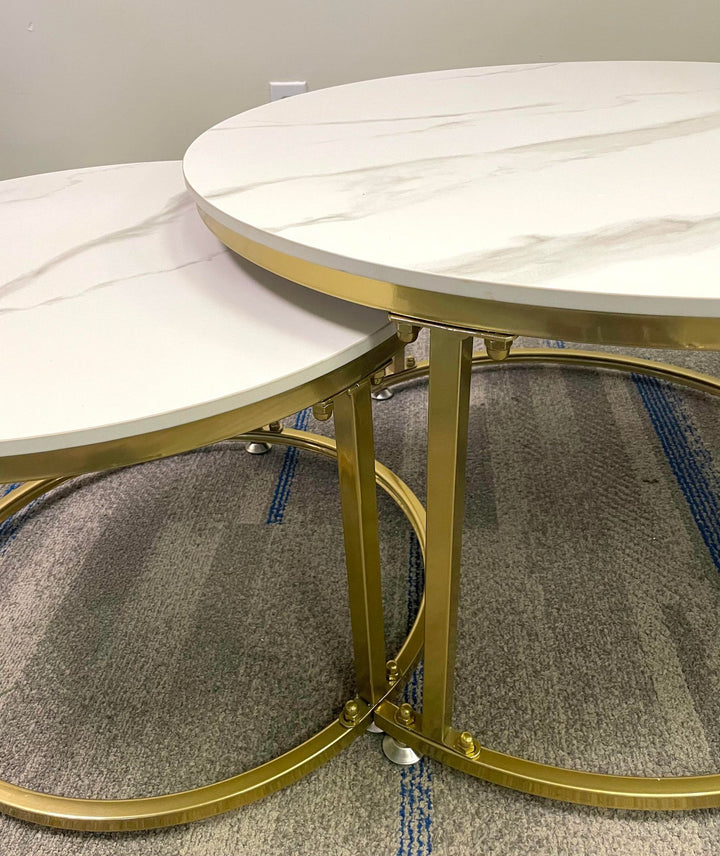 Close-up view of two round marble-top nesting coffee tables with gold metal frames, highlighting their sleek design. Common questions include 'How durable are marble-top tables?' and 'What are the advantages of nesting tables for small spaces?