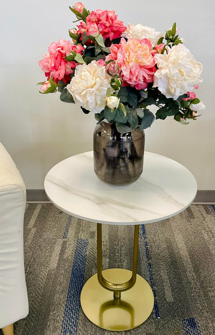 Small round marble top side table with gold base, featuring a vase with pink and cream artificial flowers. Common questions include: 'What are the best side tables for small spaces?' 'How do you style a side table?' and 'Is marble furniture easy to maintain?