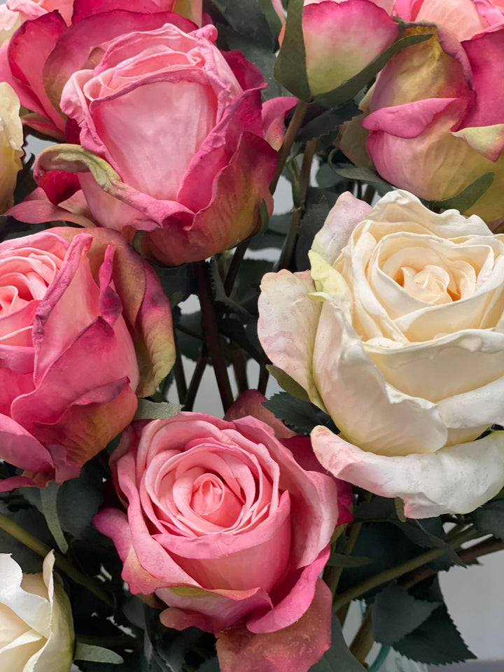 Close-up of artificial pink and white roses with detailed petal textures. Frequently asked question: What are the best tips for maintaining artificial flowers and keeping them looking fresh?