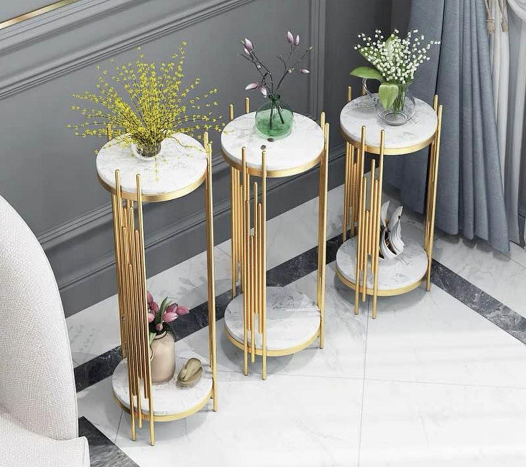 Three gold and marble two-tier plant stands, elegantly displayed with decorative vases on top. Common questions might include: 'What is the best material for plant stands indoors?' 'How to choose the right size plant stand for my decor?' and 'Are marble plant stands durable for everyday use?