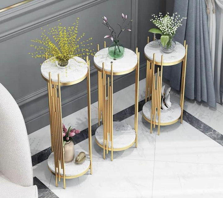 Three gold and marble two-tier plant stands, elegantly displayed with decorative vases on top. Common questions might include: 'What is the best material for plant stands indoors?' 'How to choose the right size plant stand for my decor?' and 'Are marble plant stands durable for everyday use?