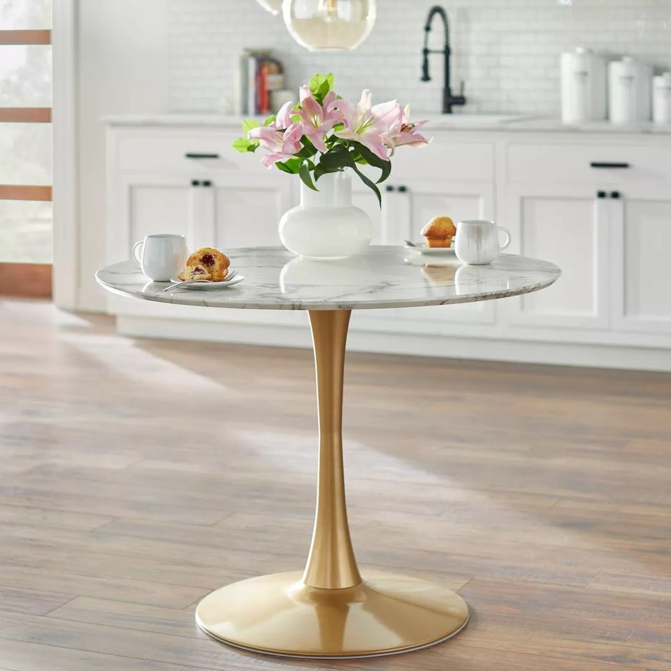 What type of table is best for a small kitchen space? This image features a modern round marble table with a sleek gold base, perfect for small dining or breakfast areas, offering a balance of elegance and functionality.