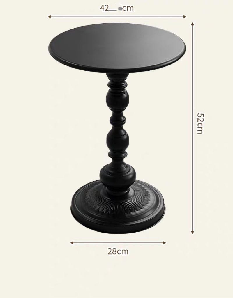 Small black round side table with an ornate pedestal base. The table's height is shown as 52 cm, the diameter of the top surface is 42 cm, and the base is 28 cm in diameter. The table's elegant and decorative design makes it suitable for modern and classic interiors alike.