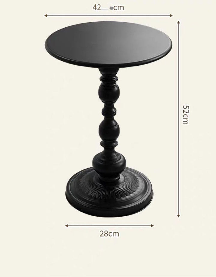 Small black round side table with an ornate pedestal base. The table's height is shown as 52 cm, the diameter of the top surface is 42 cm, and the base is 28 cm in diameter. The table's elegant and decorative design makes it suitable for modern and classic interiors alike.