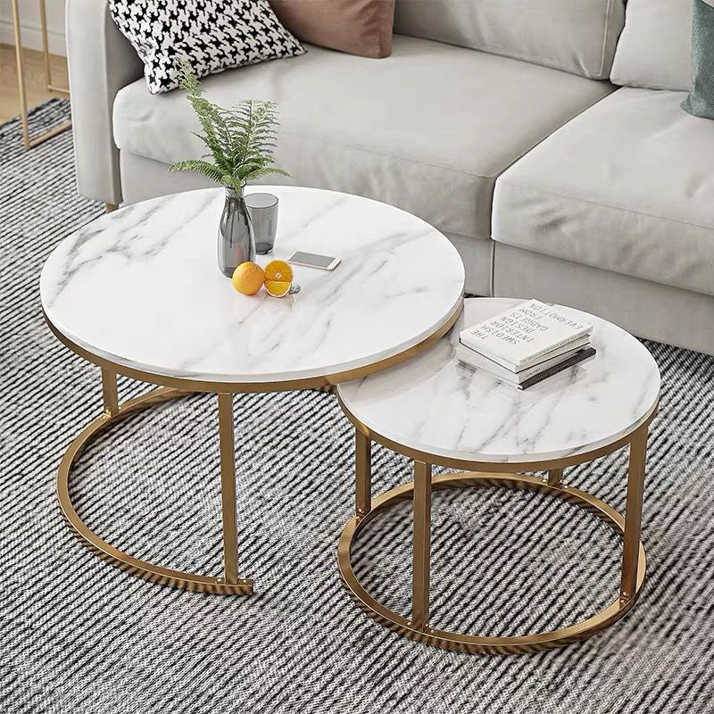Stylish round marble coffee tables with gold metal frames, featuring a nested design for modern living room setups. Common inquiries include 'What are the benefits of nesting coffee tables?' and 'How to clean and maintain a marble coffee table?