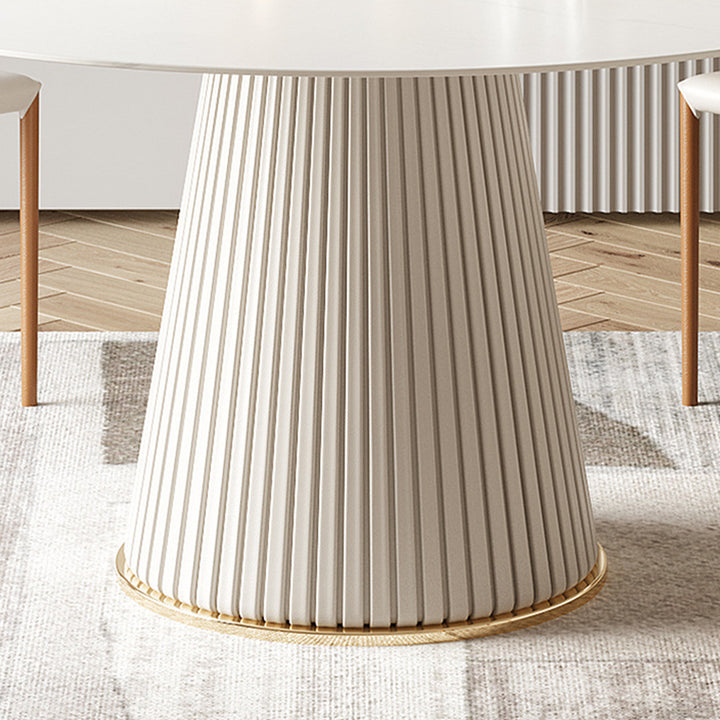 Close-up view of a modern round dining table with a distinctive fluted base and white top, showcasing elegant design and craftsmanship, perfect for contemporary home interiors.