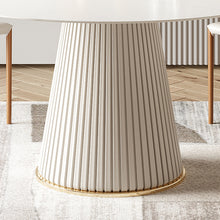 Charger l&#39;image dans la galerie, Close-up view of a modern round dining table with a distinctive fluted base and white top, showcasing elegant design and craftsmanship, perfect for contemporary home interiors.
