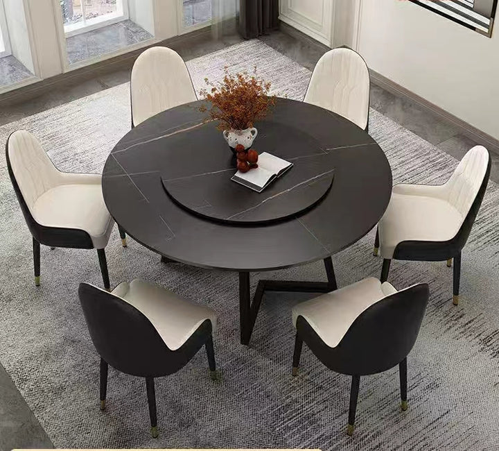Black marble round dining table with rotating center and cream-black dining chairs, set in a contemporary dining room. Popular questions include 'What are the advantages of round dining tables with a rotating center?' and 'How to maintain a marble dining table to prevent stains?