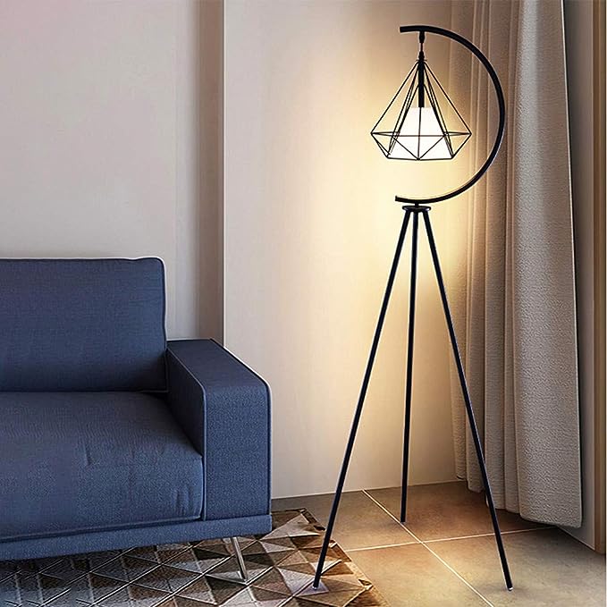 Modern geometric floor lamp with black tripod stand and crescent design – A contemporary floor lamp featuring a black tripod stand and a geometric pendant light suspended within a crescent frame near a blue sofa, perfect for modern interior decor.