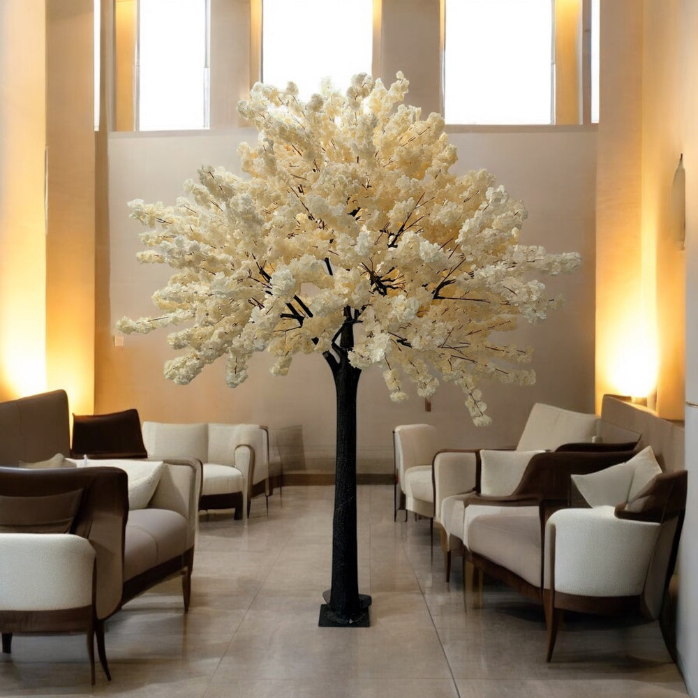 Decorative white tree in a modern living room with beige walls and furniture.