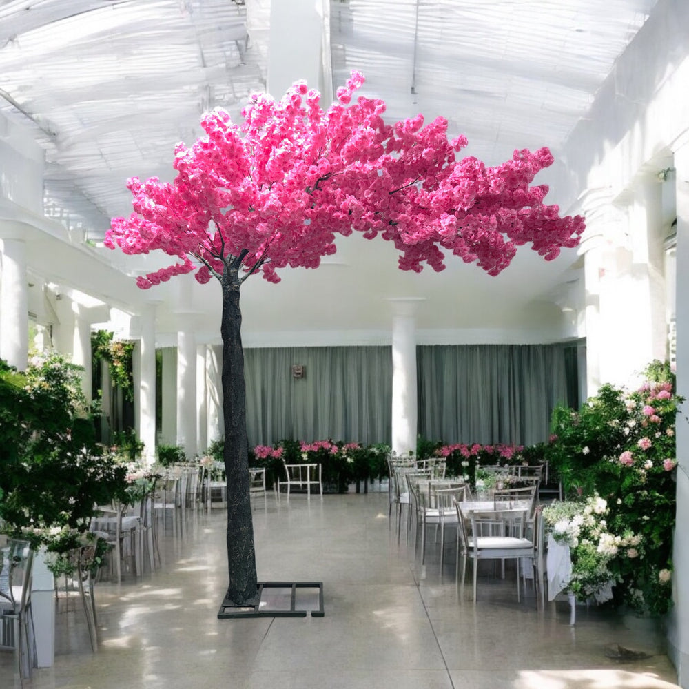 Elegant artificial cherry blossom tree with vibrant pink flowers set in a luxurious, sunlit wedding venue, adding a romantic flair to the decor. Can this artificial cherry blossom tree be customized for different event themes?