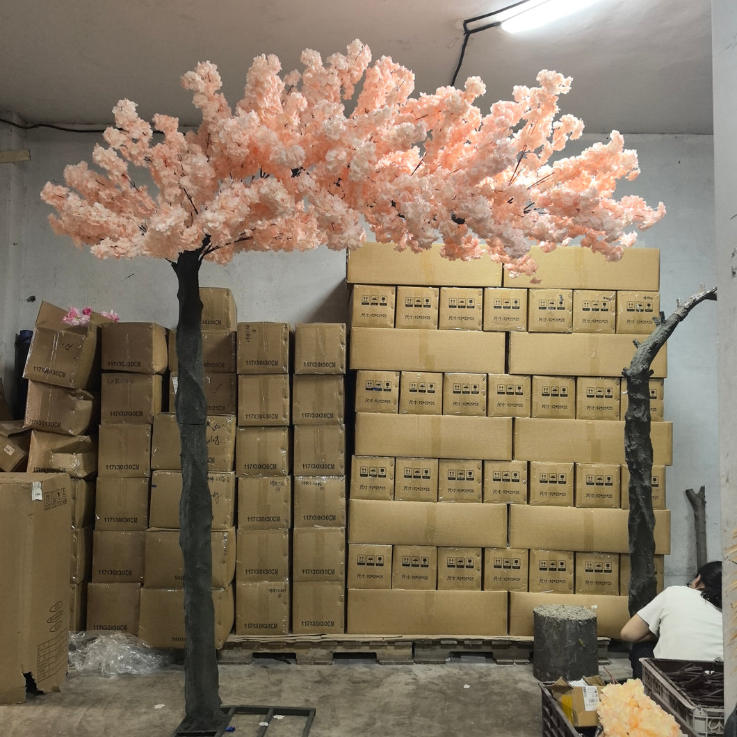 10ft artificial cherry blossom rental tree in a soft, pastel peach hue, perfect for creating a dreamy and romantic ambiance at events, weddings, or interior decor. Features realistic blossoms and a sturdy construction, ideal for enhancing the aesthetic appeal of any venue.