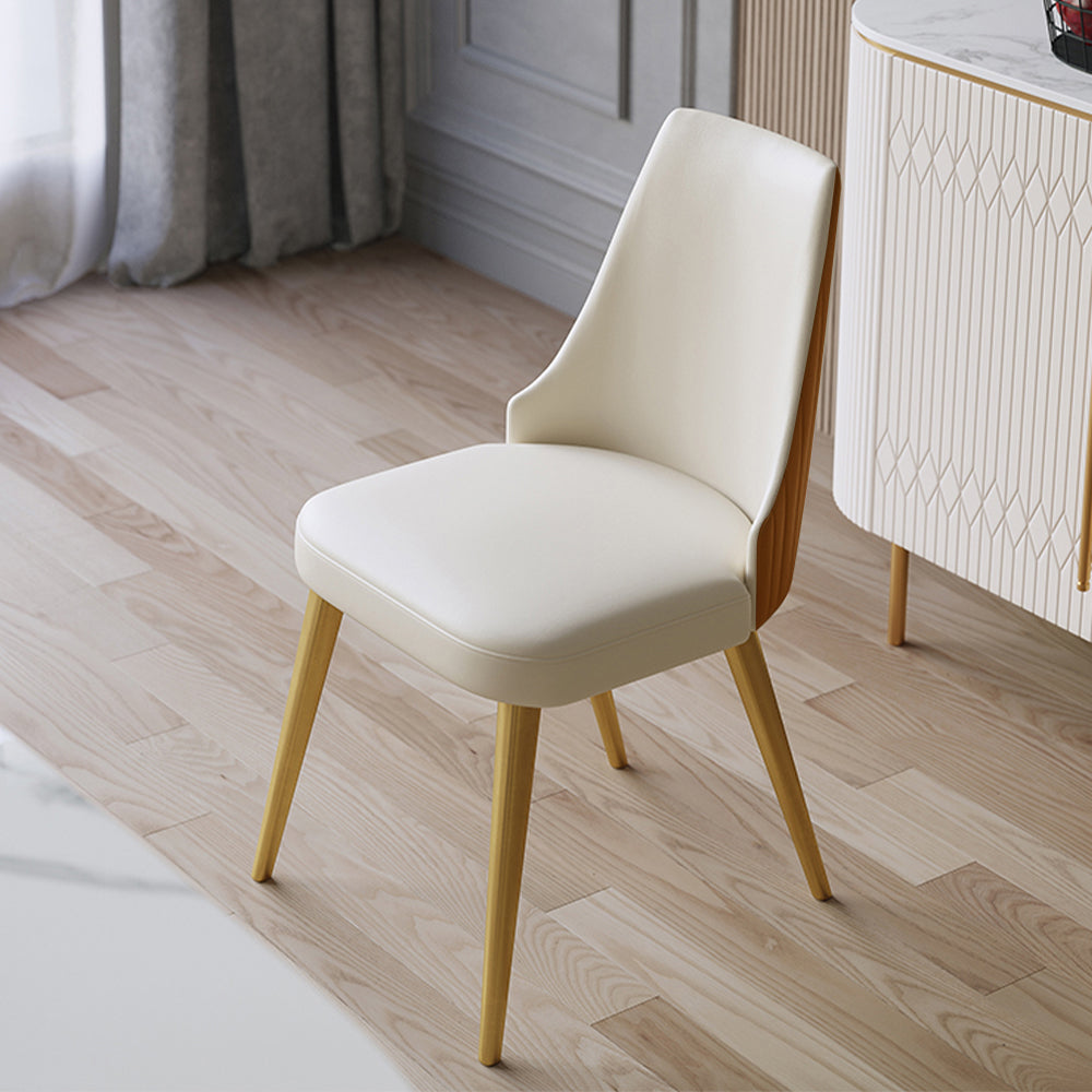 Minimalist cream-colored dining chair with wooden legs, ideal for modern interiors. Common questions include 'What type of dining chairs provide the best back support?' and 'How to choose dining chairs that match a light wood floor?