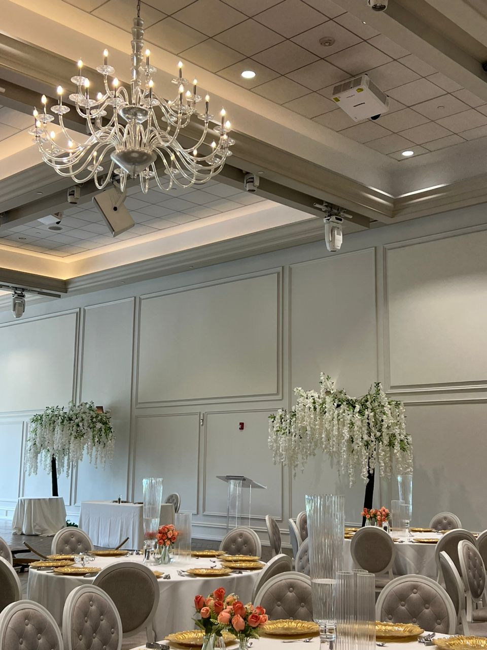 10ft white arch wisteria tree arranged at a Toronto wedding venue with cascading floral strands.