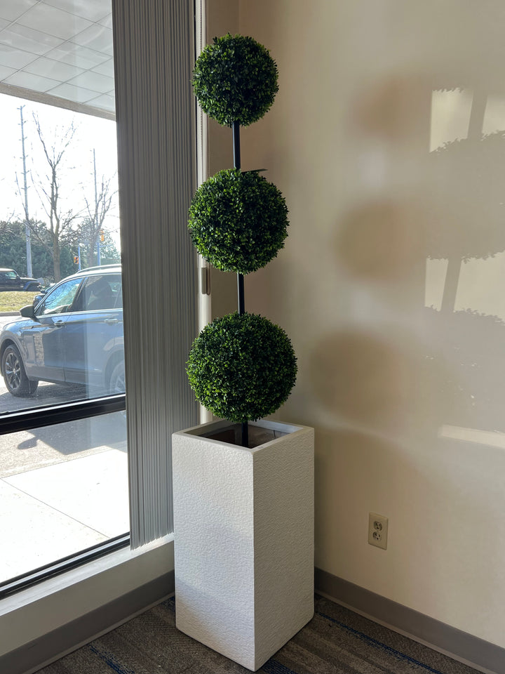 Three-tier artificial topiary tree in a modern white planter perfect for enhancing indoor spaces with a touch of greenery and style