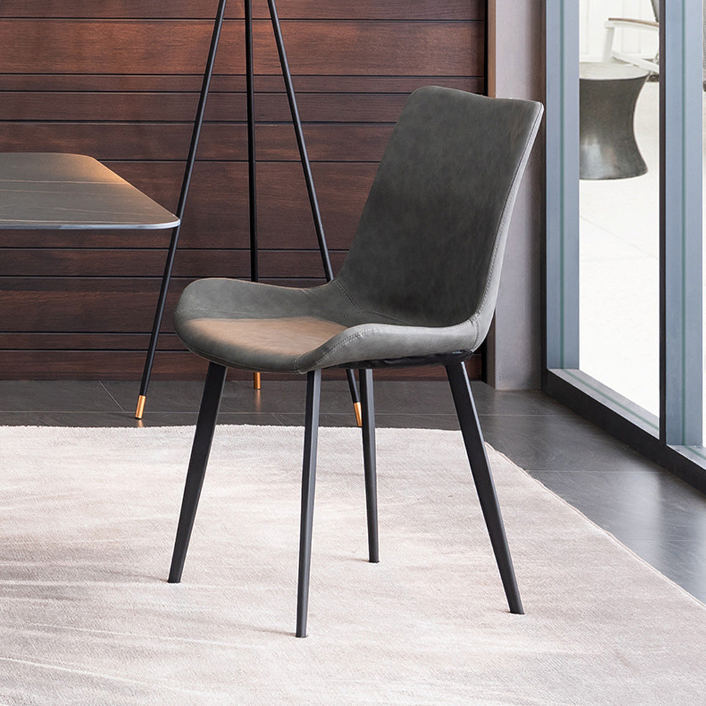 Modern minimalist dining chair with a sleek black frame and dark gray upholstered seat. Common questions include 'What materials are best for dining chairs?' and 'Are leather dining chairs comfortable for everyday use?