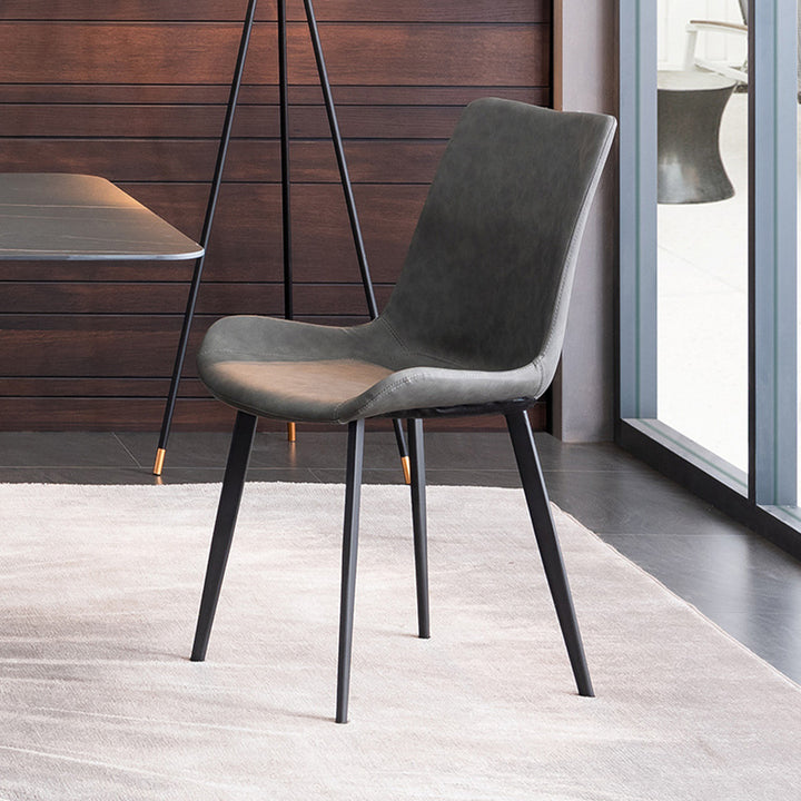 Modern minimalist dining chair with a sleek black frame and dark gray upholstered seat. Common questions include 'What materials are best for dining chairs?' and 'Are leather dining chairs comfortable for everyday use?
