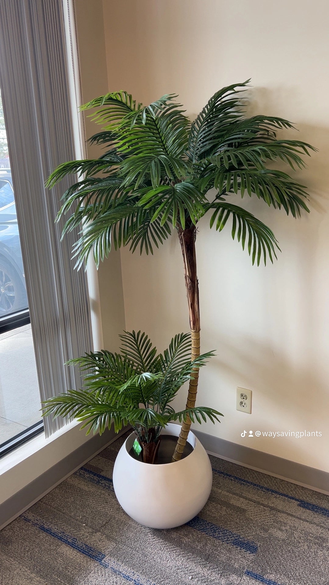 Artificial palm tree in a stylish white planter pot, ideal for enhancing modern living rooms or office environments.