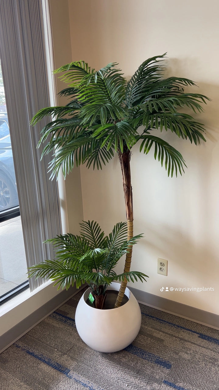 Artificial palm tree in a stylish white planter pot, ideal for enhancing modern living rooms or office environments.