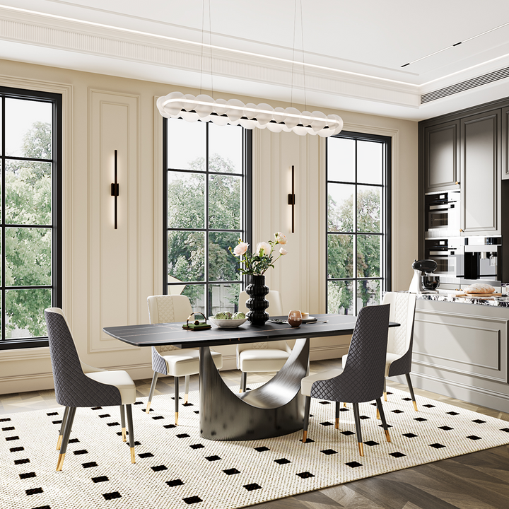 Modern dining table with a sleek black top and an artistic curved base, complemented by stylish chairs in a contemporary dining room setting