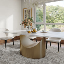 Load image into Gallery viewer, Modern dining table with a white marble surface and a unique gold crescent-shaped base, complemented by white upholstered chairs
