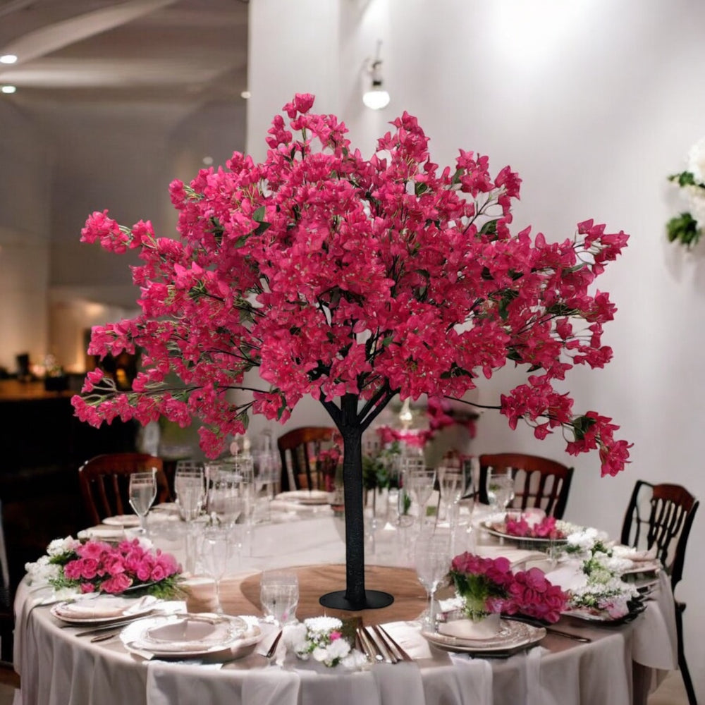 Decorative table setting with a pink floral centerpiece in a restaurant.