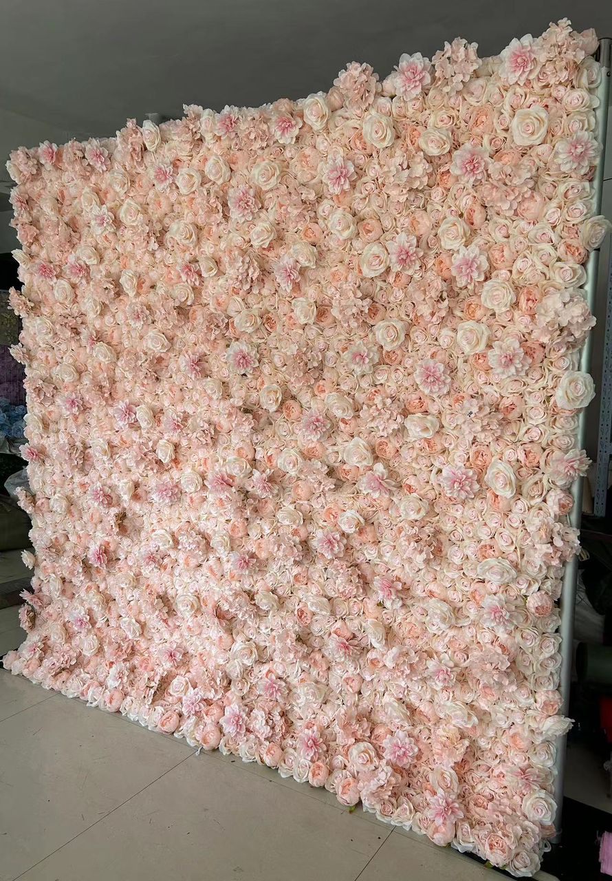 Artificial flower wall in soft blush and peach tones, featuring roses and peonies, perfect for weddings, parties, and photography backdrops. Is this flower wall easy to set up and transport? How durable are the flowers in different weather conditions? Can this backdrop be customized in size or color for specific events?