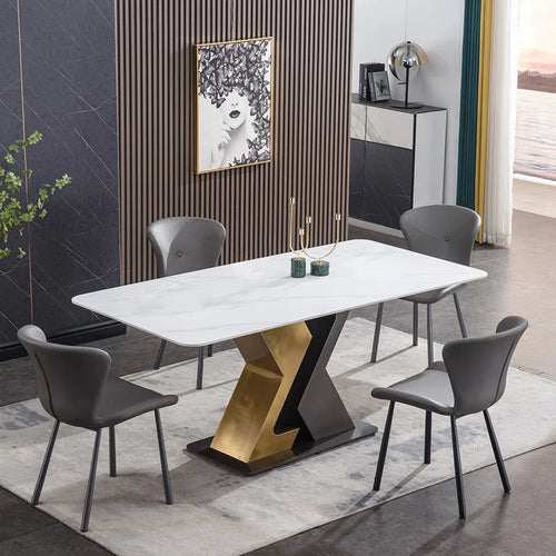 Modern rectangular white marble dining table with black and gold geometric base, surrounded by gray upholstered chairs in a stylish dining area with wood accent wall