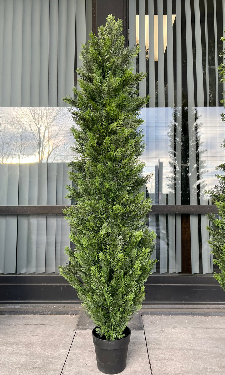 Artificial tall evergreen plant in a black pot, featuring lush green foliage with subtle yellow accents, perfect for outdoor or indoor decor.