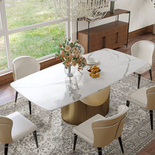 Load image into Gallery viewer, Elegant dining table with a white marble top and gold cylindrical base, perfectly accented with comfortable cream-colored chairs
