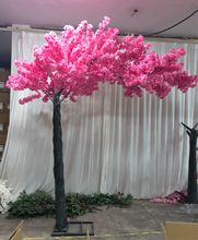 Charger l&#39;image dans la galerie, Artificial cherry blossom tree in vibrant pink, staged against a white curtain backdrop with additional floral components on the floor. Is this cherry blossom tree available for rental for indoor events?
