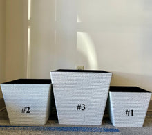 Load image into Gallery viewer, Three white textured square planters labeled #1, #2, and #3, arranged side by side. The planters vary in size, with #1 being the smallest, #2 medium-sized, and #3 the largest. The interior of each planter is black, providing a modern contrast to the white exterior.
