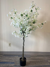 Load image into Gallery viewer, Artificial white flower tree with abundant blossoms in a modern white round planter, placed against a light-colored wall on a carpeted floor.
