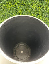 Load image into Gallery viewer, Interior view of a large white textured planter with a black lining and drainage hole, set against a green artificial plant backdrop. Common questions: Do planters need drainage holes for artificial plants? How do you ensure proper drainage with indoor planters? What type of liner works best for large planters?
