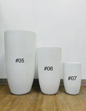 Load image into Gallery viewer, Three white planters of different sizes labeled as #05, #06, and #07, placed on a wooden floor against a plain background. How do I select the right size planter for indoor plants?
