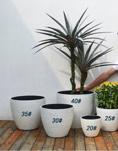 Load image into Gallery viewer, Set of outdoor planters in various sizes (#20 to #40), showcasing different artificial plants. Frequently asked questions: What size planter is ideal for large artificial trees? Are these outdoor planters weather-resistant? Can these planters be used indoors as well?
