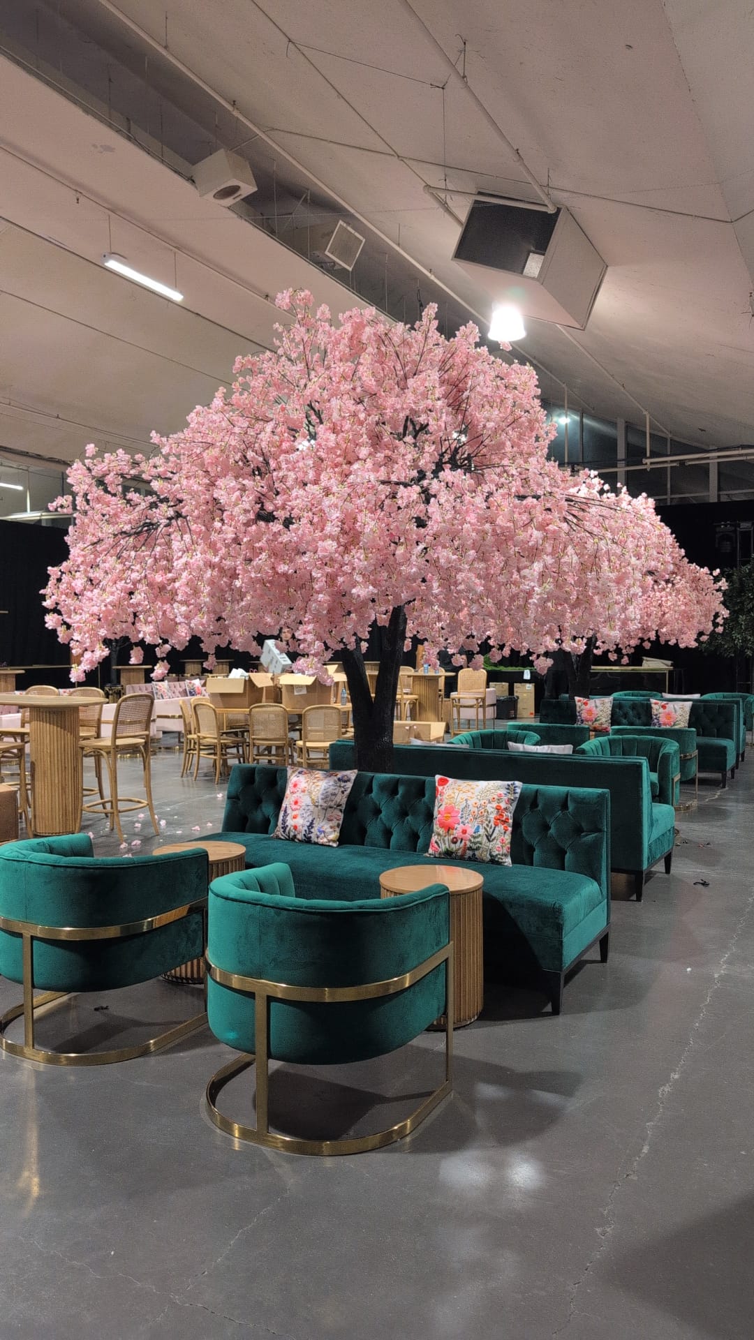 Large pink artificial cherry blossom tree at event venue 