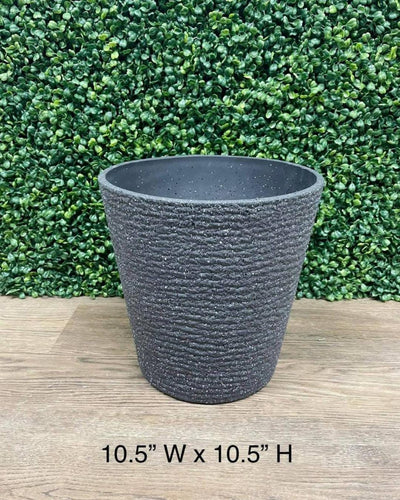 Gray textured planter measuring 10.5 inches wide by 10.5 inches high, displayed against a green leafy backdrop on a wooden floor.